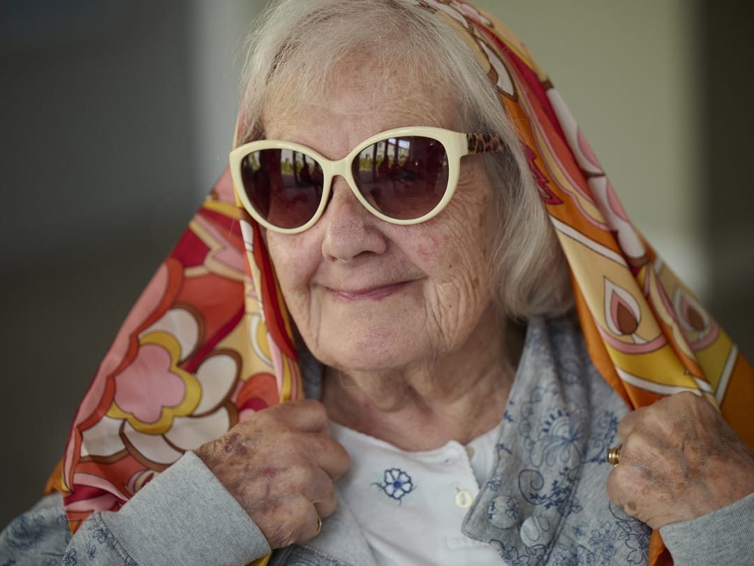 Hilda from Church Farm wears a vibrant, patterned headscarf
